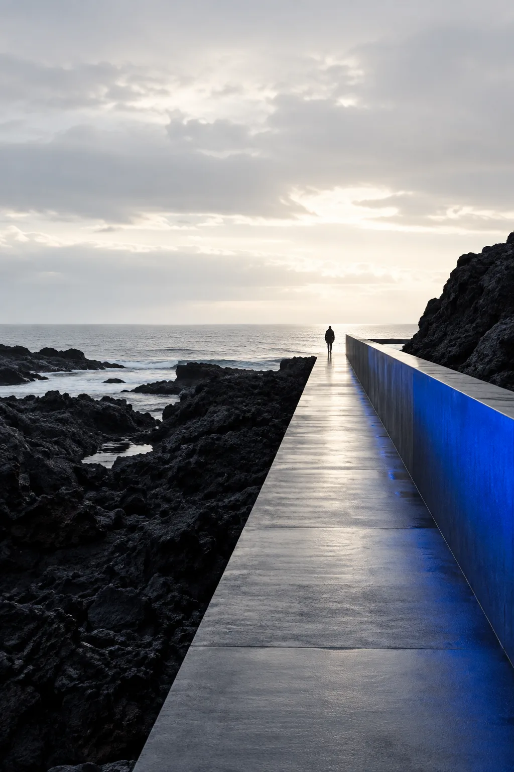 A quiet coastal pathway leading toward an open horizon